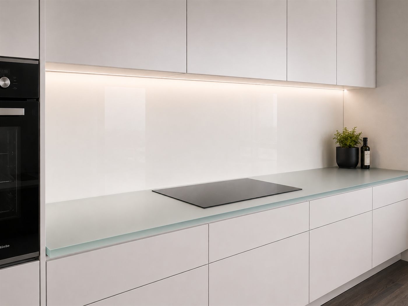 Weiße Hochglanz-Glasrückwand über heller Küchenzeile mit LED-Unterbaulicht